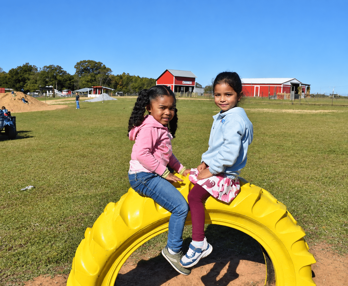 Two girls are sitting on big tire-2